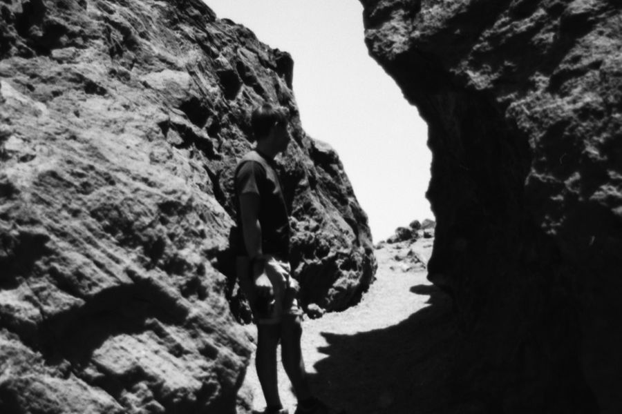 A hiker standing in a narrow rock passage