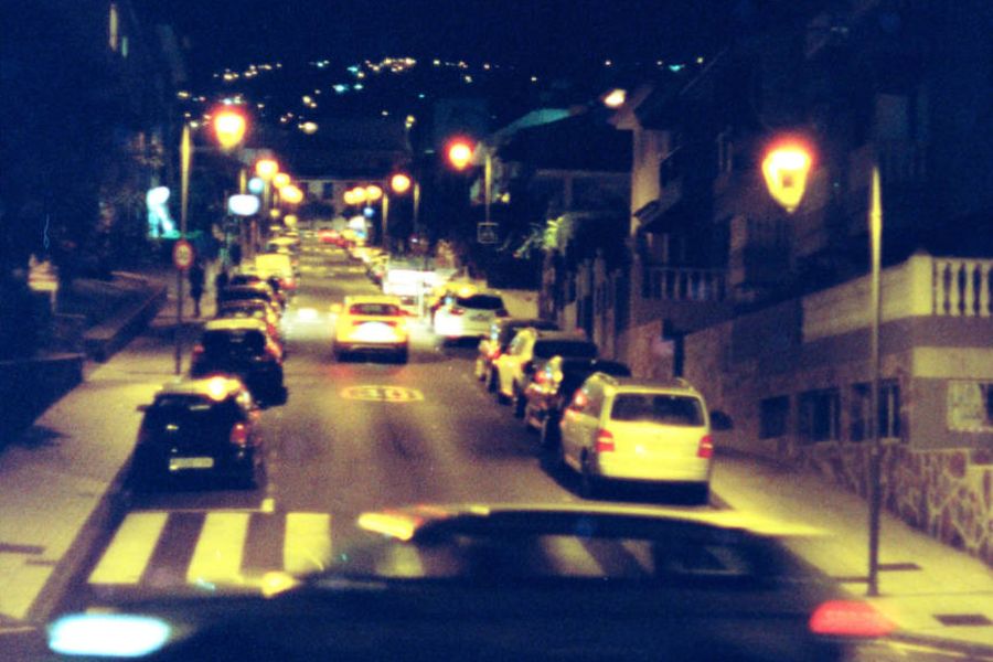 Cars and street lights on a road at night