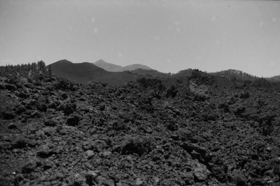 A black lava field with the Teide on the horizon