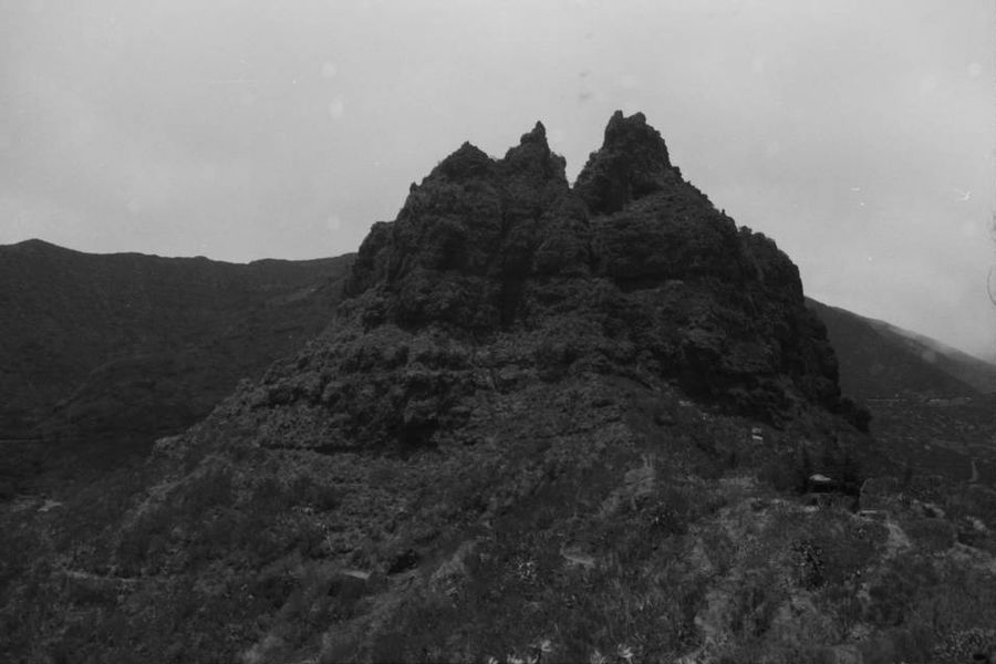 Two rocky peaks rising out of the hillside